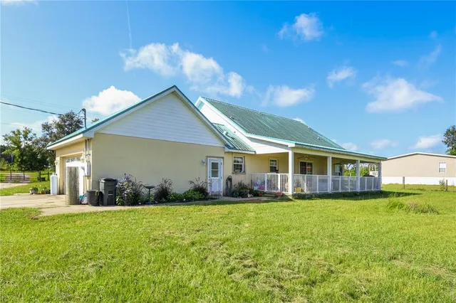 a front view of house with yard and green space