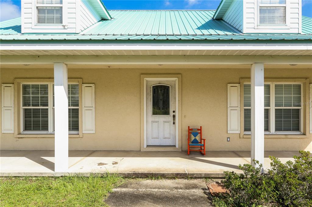 7290 Northeast 106 Terrace Bronson, FL 32621 - Photo 8 of 40 front view of a house with a small yard