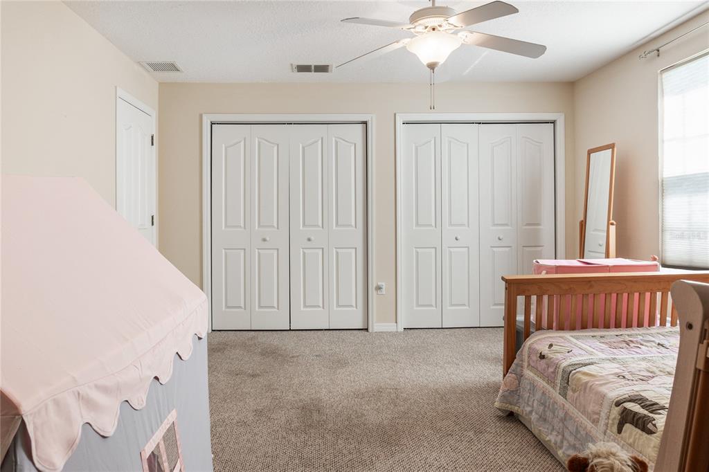 7290 Northeast 106 Terrace Bronson, FL 32621 - Photo 9 of 40 a bedroom with a bed and a chandelier