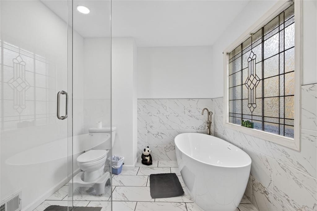 2222 Amber Creek Trail Buford, GA 30519 - Photo 16 of 51 a bathroom with a sink a toilet and shower