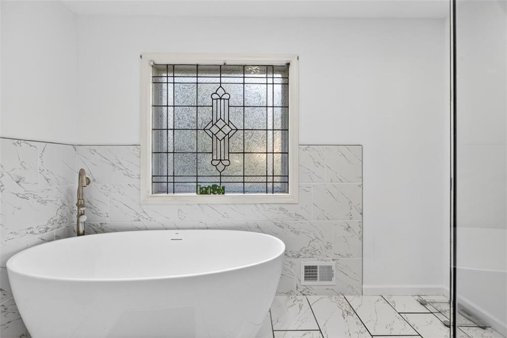 2222 Amber Creek Trail Buford, GA 30519 - Photo 17 of 51 a white bath tub sitting in a bathroom