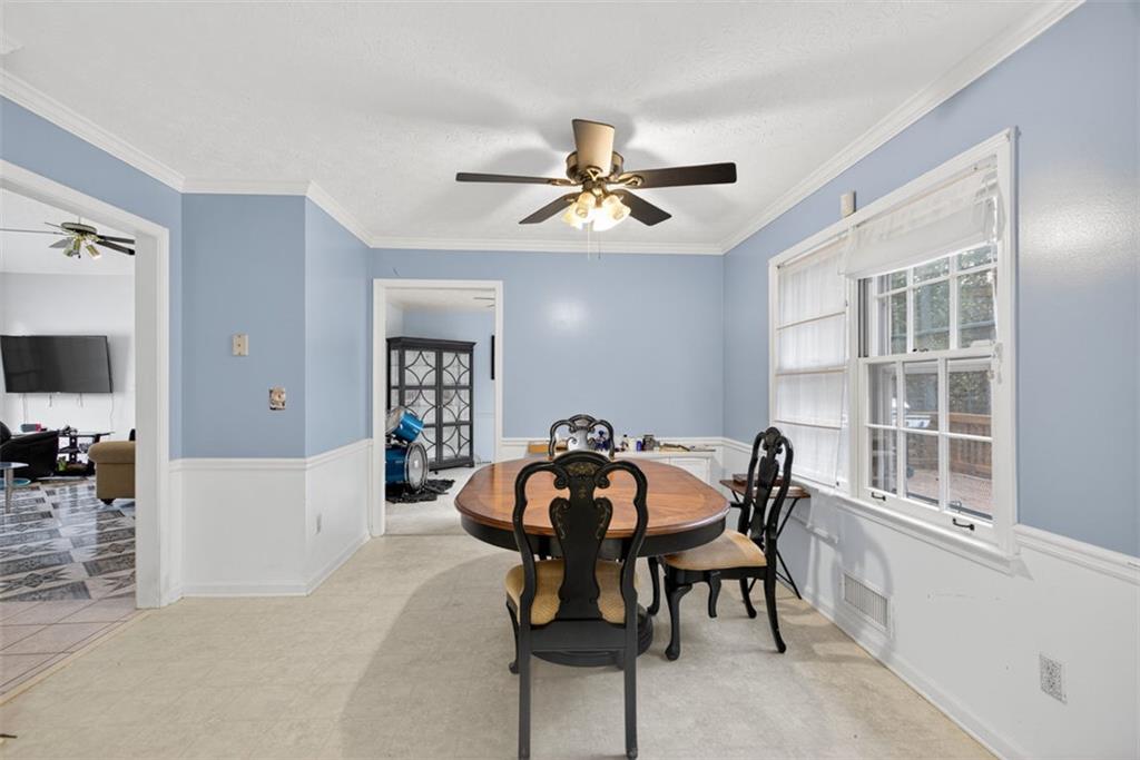 2222 Amber Creek Trail Buford, GA 30519 - Photo 21 of 51 a view of a dining room and livingroom with furniture wooden floor a rug a flat screen tv