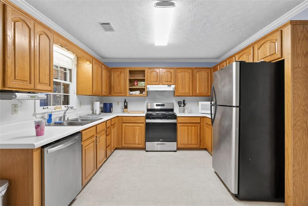2222 Amber Creek Trail Buford, GA 30519 - Photo 22 of 51 a kitchen with a refrigerator sink and stove
