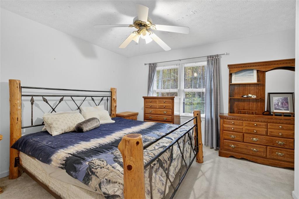 2222 Amber Creek Trail Buford, GA 30519 - Photo 30 of 51 a bedroom with a bed and a dresser