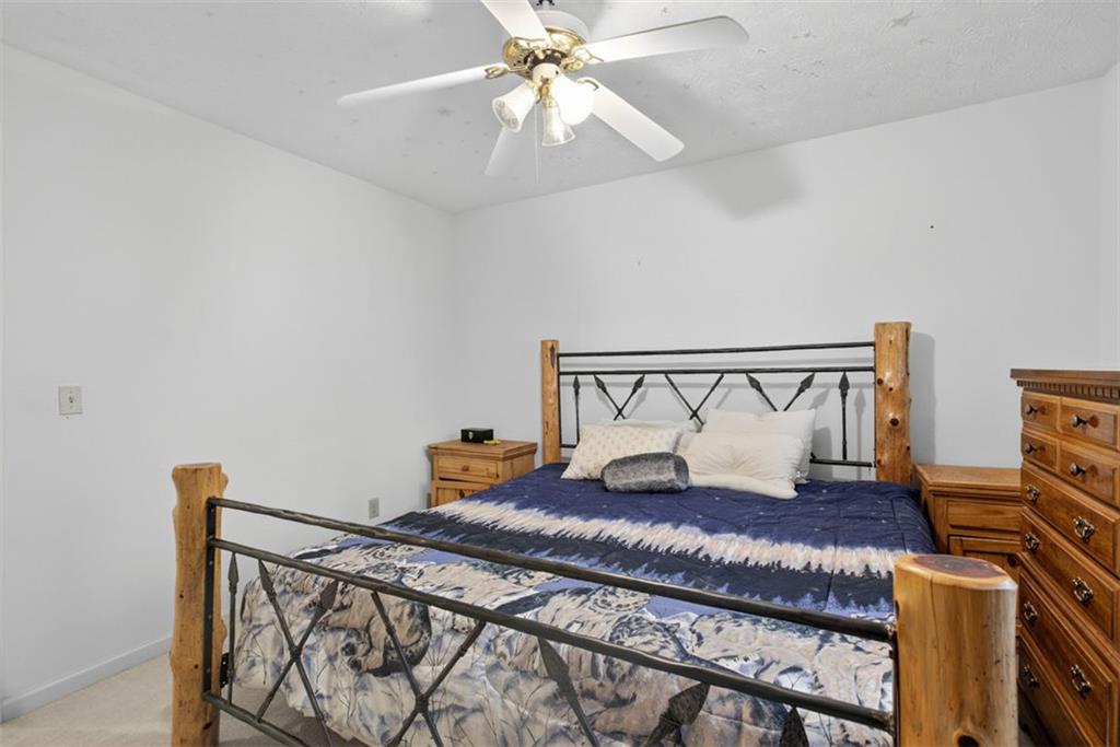 2222 Amber Creek Trail Buford, GA 30519 - Photo 31 of 51 a large bed sitting in a bedroom next to a lamp