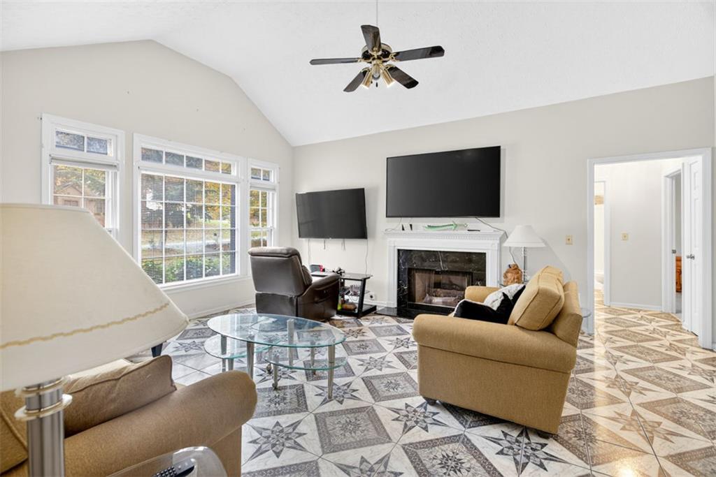 2222 Amber Creek Trail Buford, GA 30519 - Photo 6 of 51 a living room with furniture a fireplace and a flat screen tv