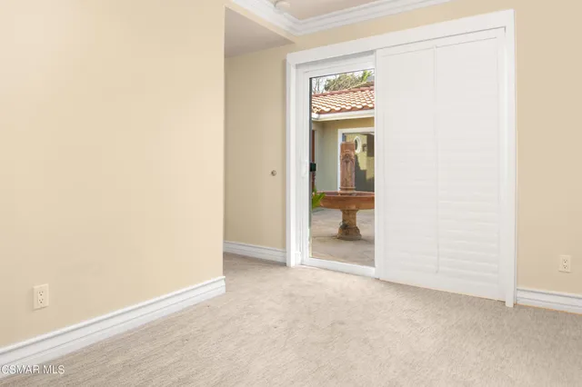 an entryway of a house and an empty room