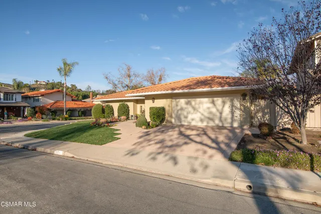 a view of a white house with a yard