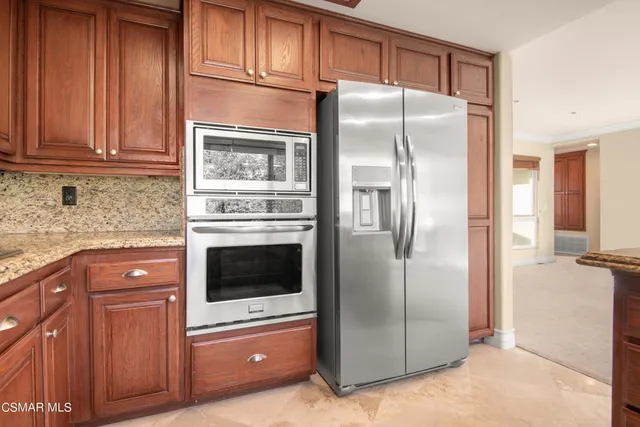 a kitchen with cabinets and stainless steel appliances