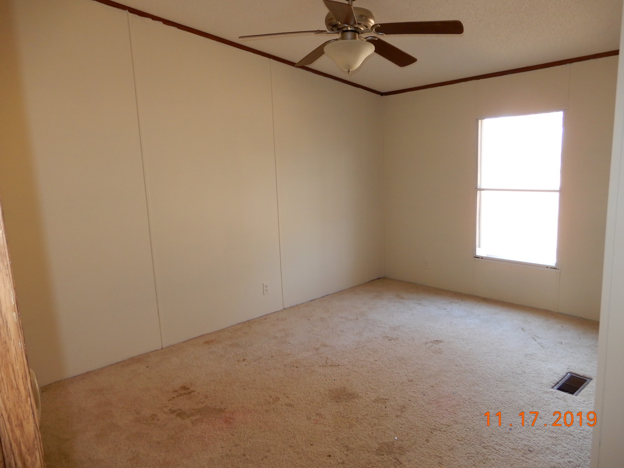 10408 Wilder Point Road Bon Aqua, TN 37025 - Photo 12 of 27 an empty room with a window and a fan