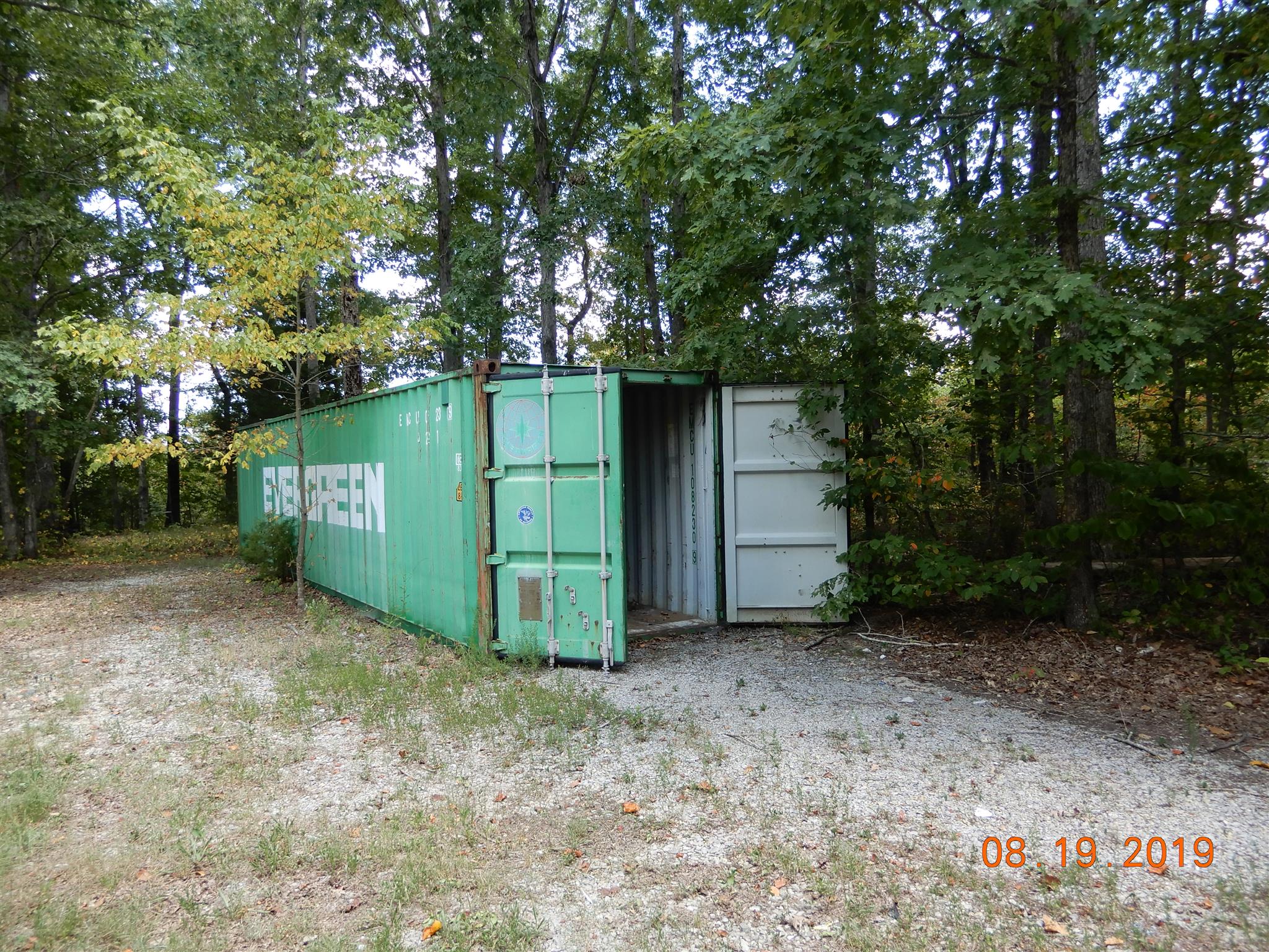 10408 Wilder Point Road Bon Aqua, TN 37025 - Photo 20 of 27 a view of a tiny house with large trees