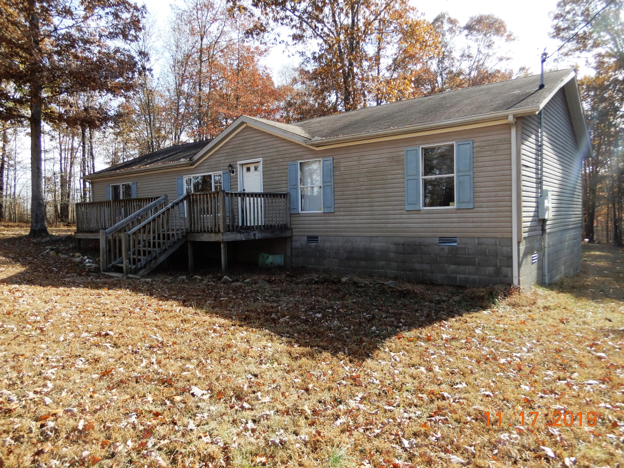 10408 Wilder Point Road Bon Aqua, TN 37025 - Photo 24 of 27 a front view of a house with a yard and garage