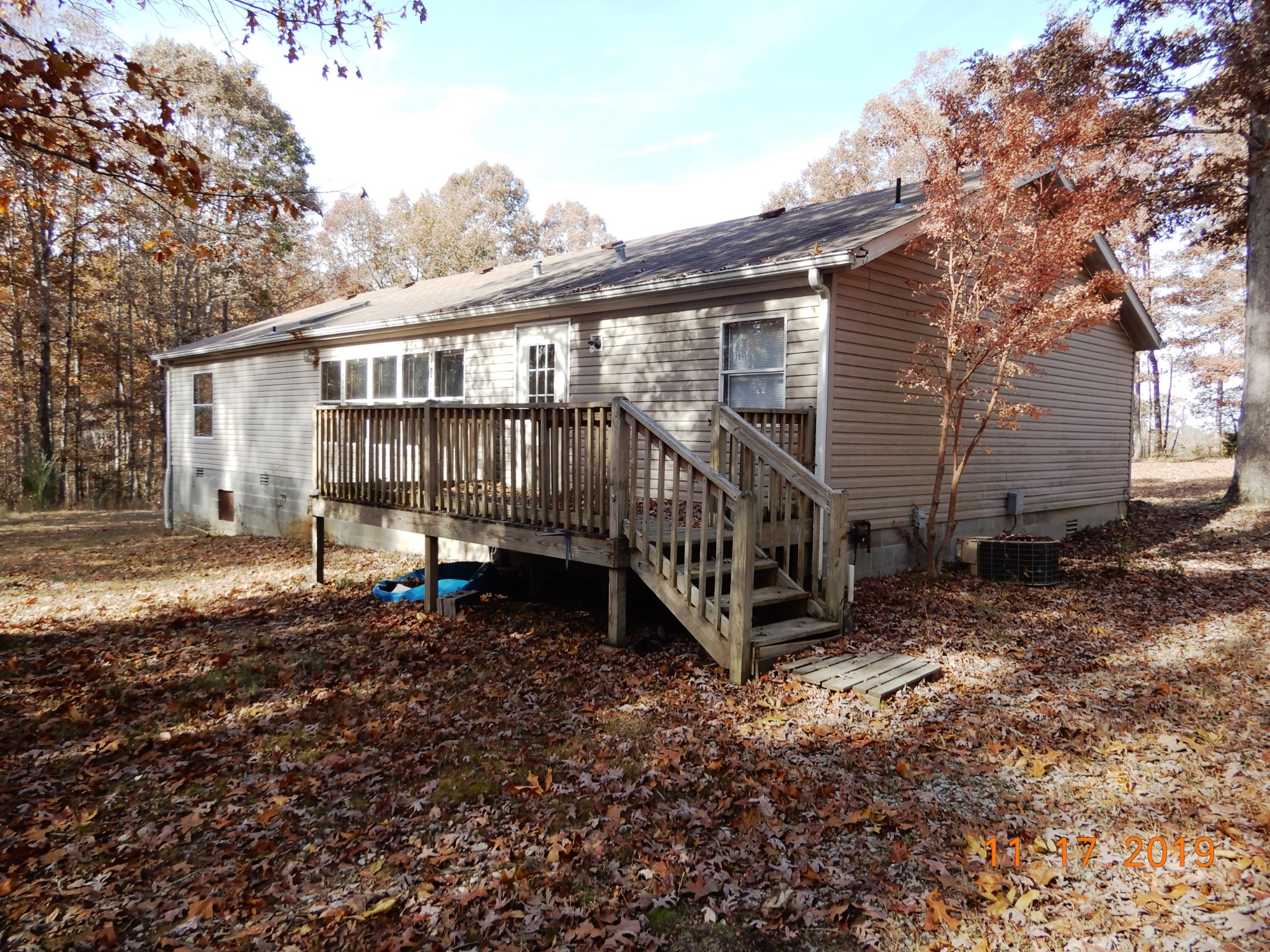 10408 Wilder Point Road Bon Aqua, TN 37025 - Photo 27 of 27 a view of a house with backyard and deck