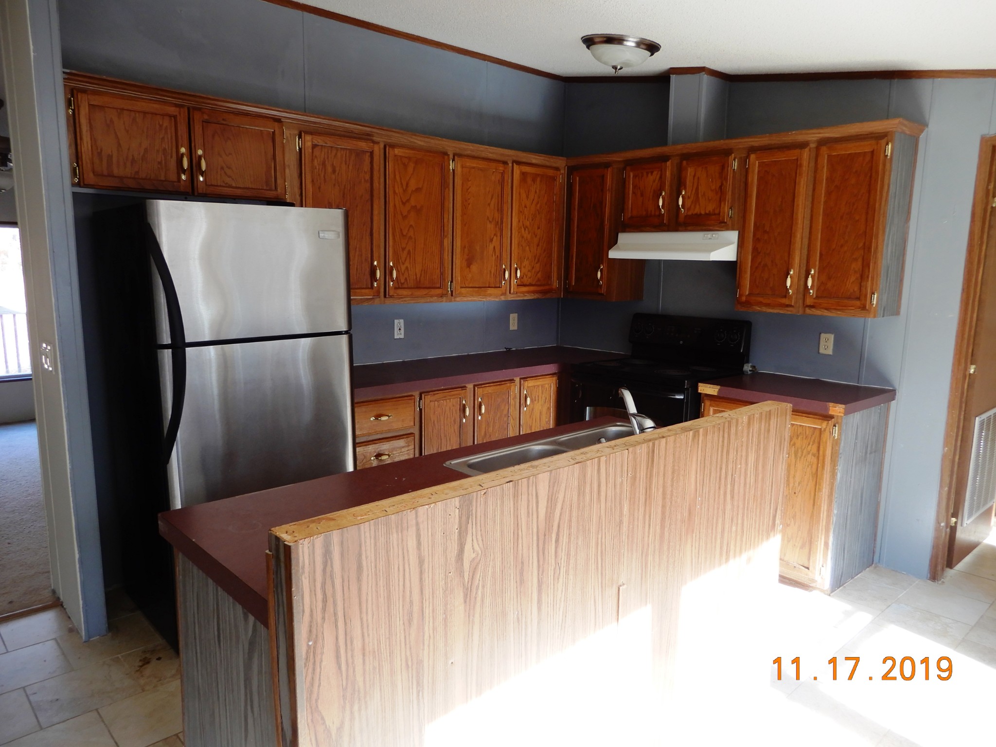 10408 Wilder Point Road Bon Aqua, TN 37025 - Photo 6 of 27 a kitchen with refrigerator and cabinets