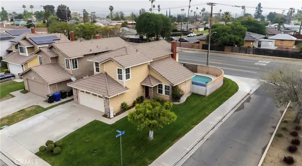 an aerial view of a house with garden space and street view