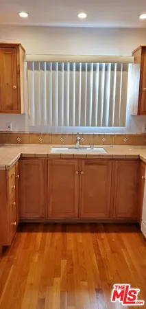 a view of a kitchen with wooden floor