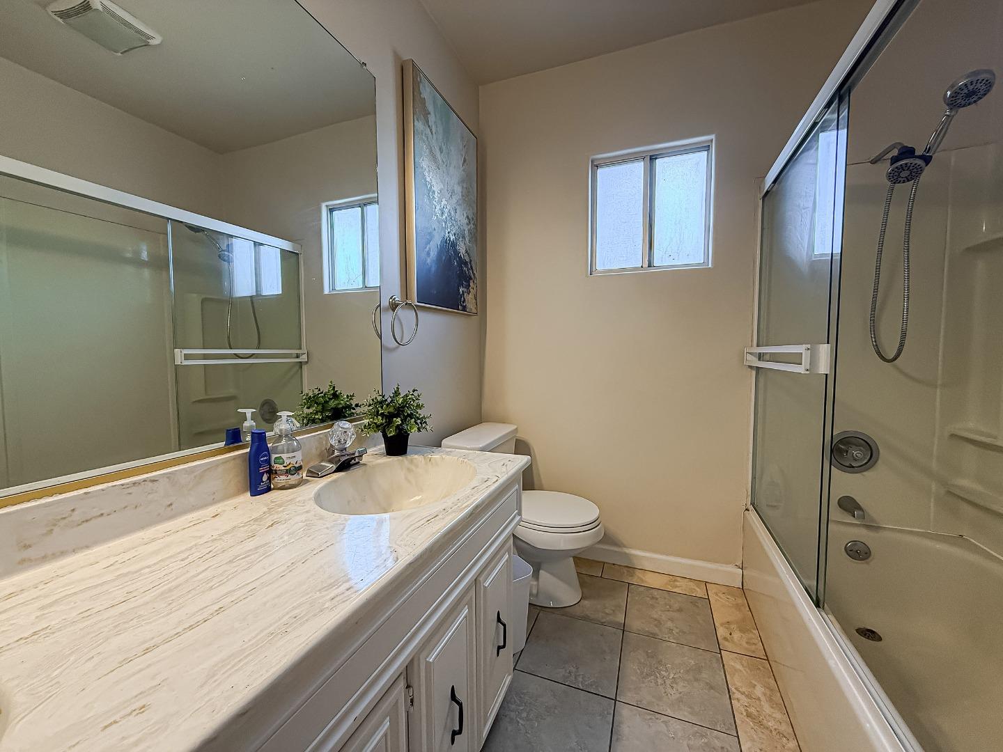 558 A Street Hayward, CA 94541 - Photo 14 of 37 a bathroom with a sink a toilet and shower