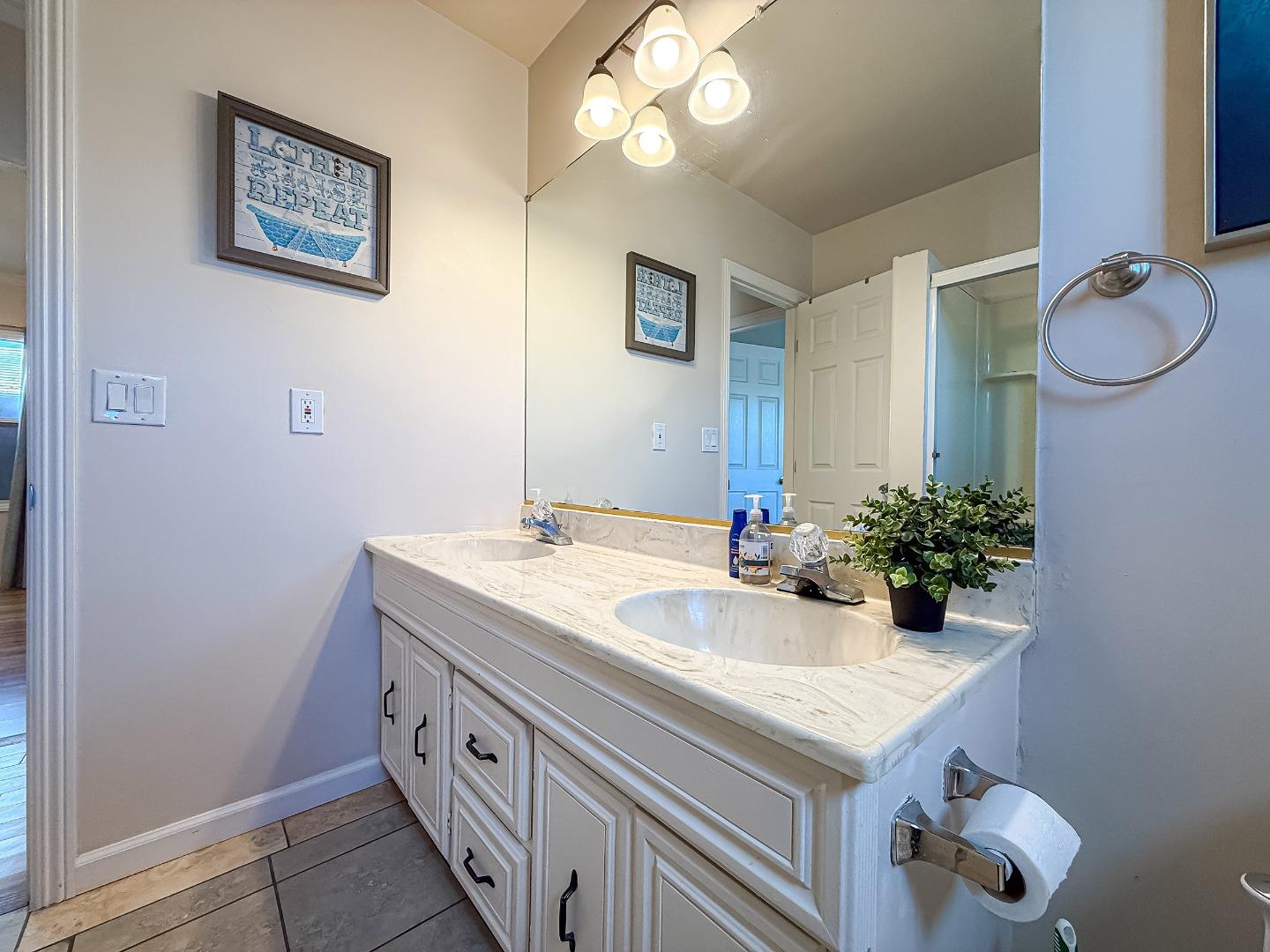 558 A Street Hayward, CA 94541 - Photo 15 of 37 a bathroom with a granite countertop sink and a mirror