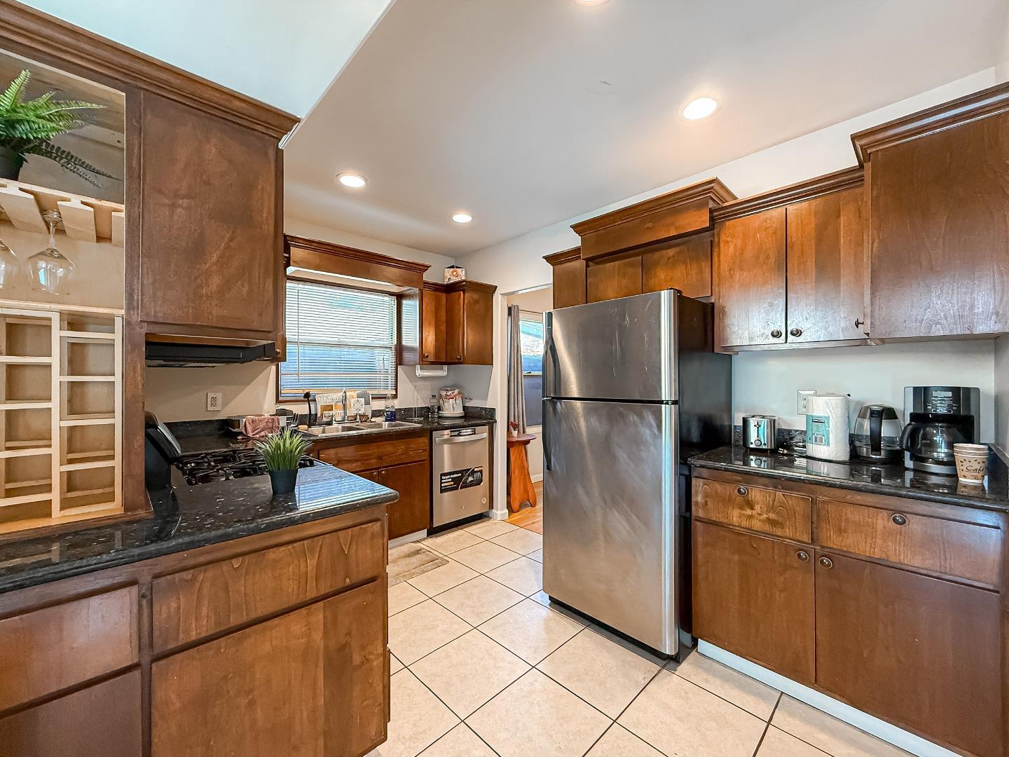 558 A Street Hayward, CA 94541 - Photo 9 of 37 a kitchen with stainless steel appliances granite countertop a refrigerator a sink a stove a microwave and cabinets