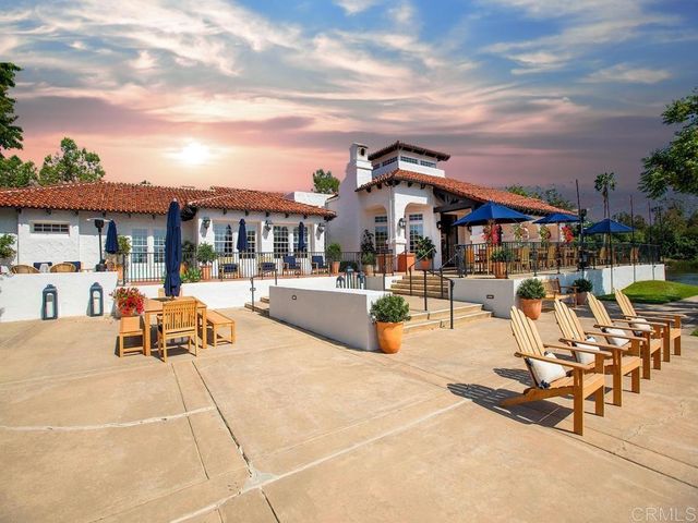 a view of a garden with sitting area
