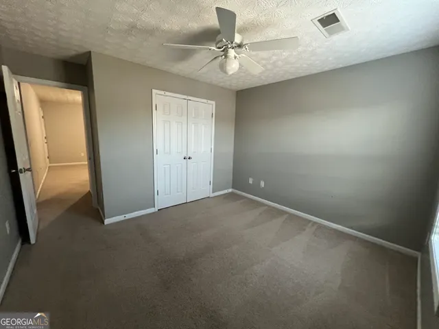 a view of an empty room with a fan