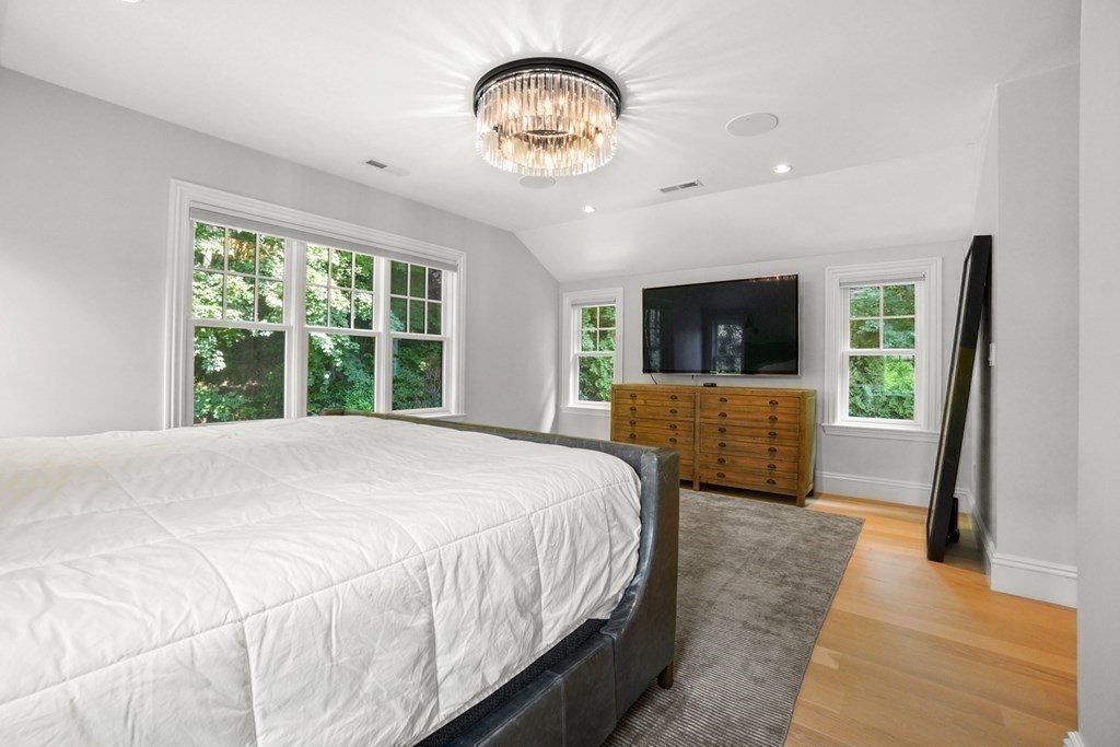 12 Swarthmore Road Wellesley, MA 02482 - Photo 24 of 38 a spacious bedroom with a large bed and a chandelier