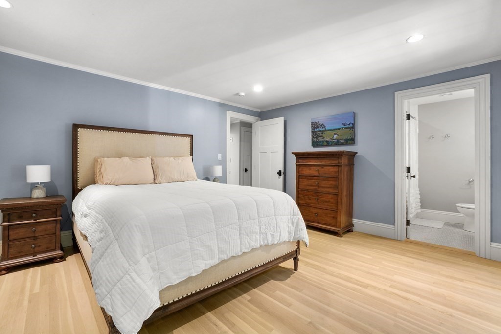 12 Swarthmore Road Wellesley, MA 02482 - Photo 29 of 38 a bedroom with a large bed a chandelier and closet