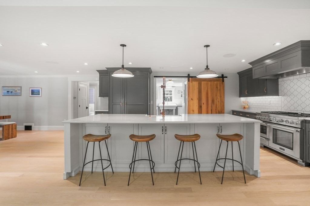 12 Swarthmore Road Wellesley, MA 02482 - Photo 8 of 38 a kitchen with stainless steel appliances granite countertop a stove a sink dishwasher and a refrigerator with wooden floor