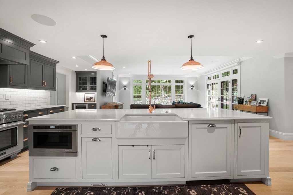 12 Swarthmore Road Wellesley, MA 02482 - Photo 9 of 38 a kitchen with stainless steel appliances granite countertop a stove a sink and white cabinets