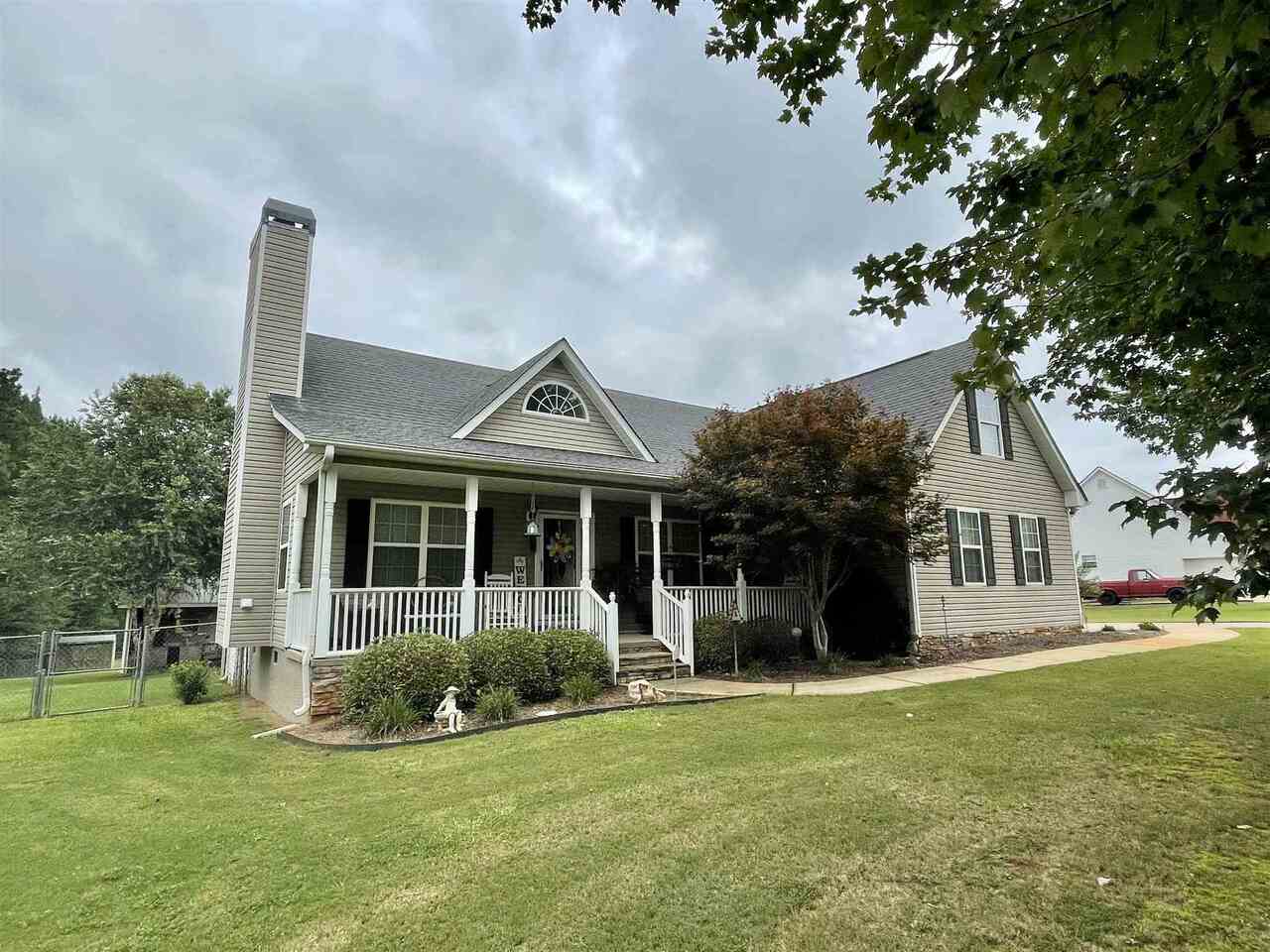 a front view of a house with a garden