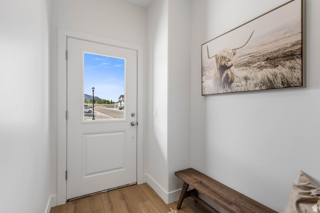 636 West Caroles Way, Unit 7 Tooele, UT 84074 - Photo 3 of 31 Entryway featuring a paneled door with an upper glass pane, light wood-finish flooring, and white baseboards