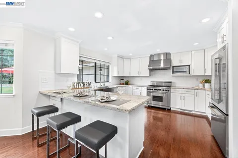 a kitchen with sink cabinets and wooden floor
