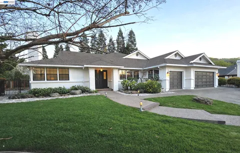 a front view of a house with a garden and yard