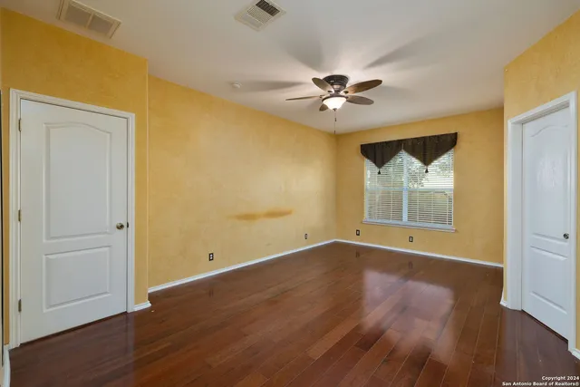 a bathroom with a granite countertop sink mirror and a bathtub next to a window