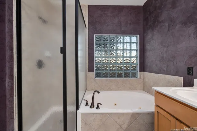 a view of room with wooden floor and fan