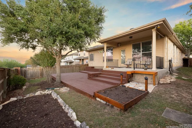 a view of a house with backyard and sitting area
