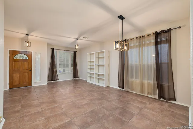 a view of a room with cabinet and windows