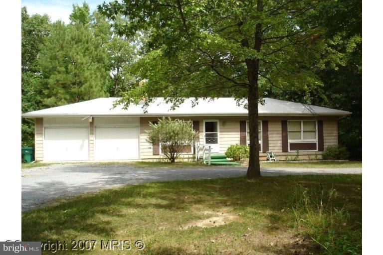 13280 Joy Road Lusby, MD 20657 - Photo 1 of 1 a front view of a house with a yard