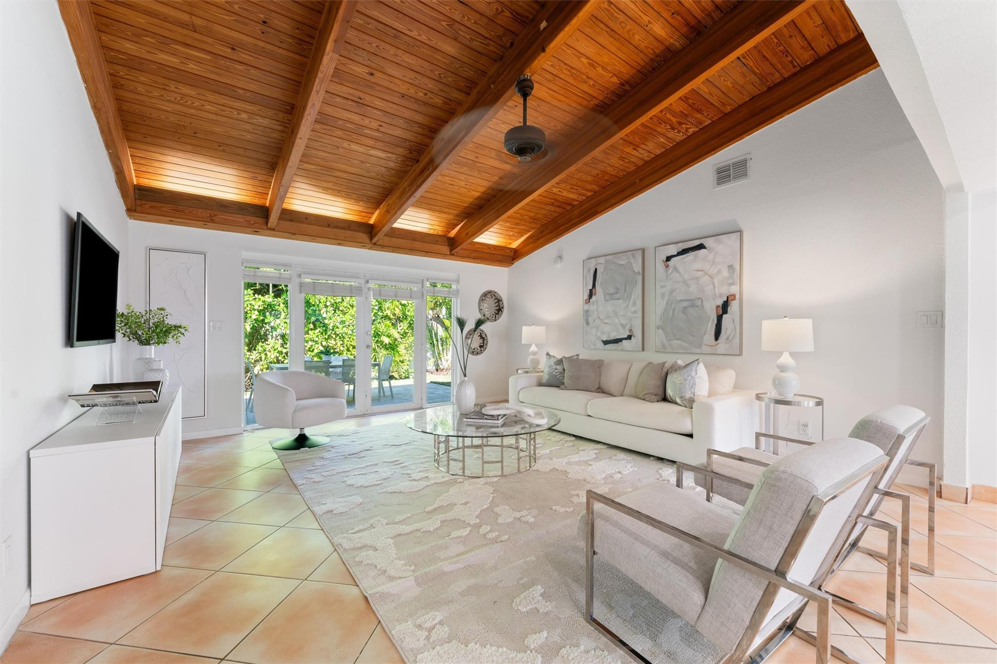 3203 Dover Road Pompano Beach, FL 33062 - Photo 14 of 45 a living room with furniture a flat screen tv and a floor to ceiling window