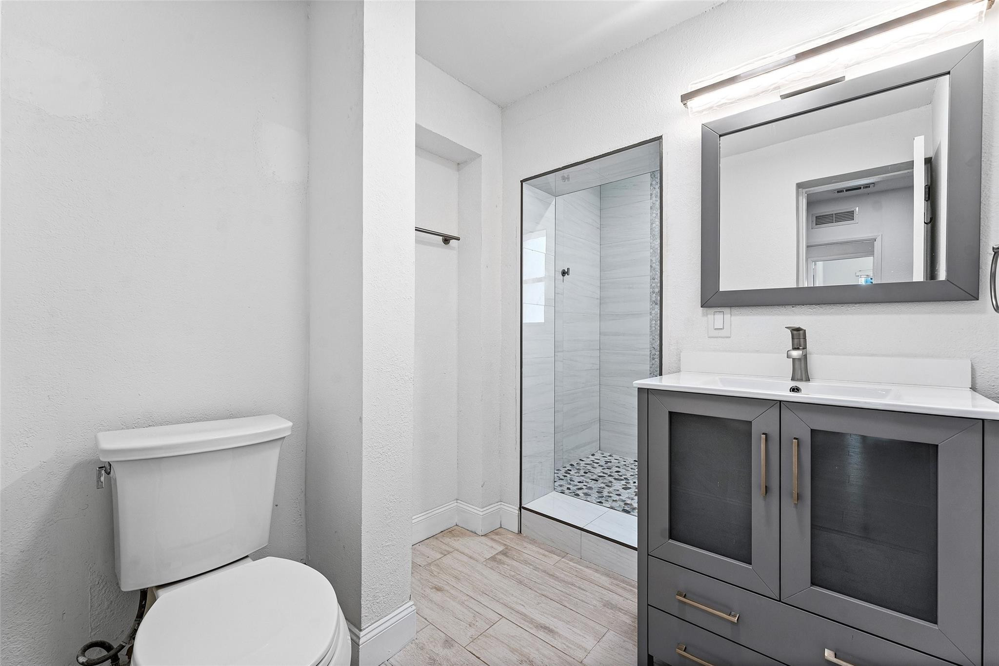 3203 Dover Road Pompano Beach, FL 33062 - Photo 24 of 45 a bathroom with a toilet sink and mirror