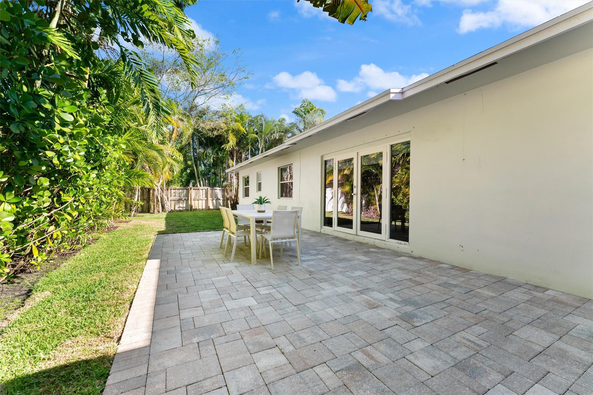 3203 Dover Road Pompano Beach, FL 33062 - Photo 30 of 45 a view of a patio with table and chairs and potted plants