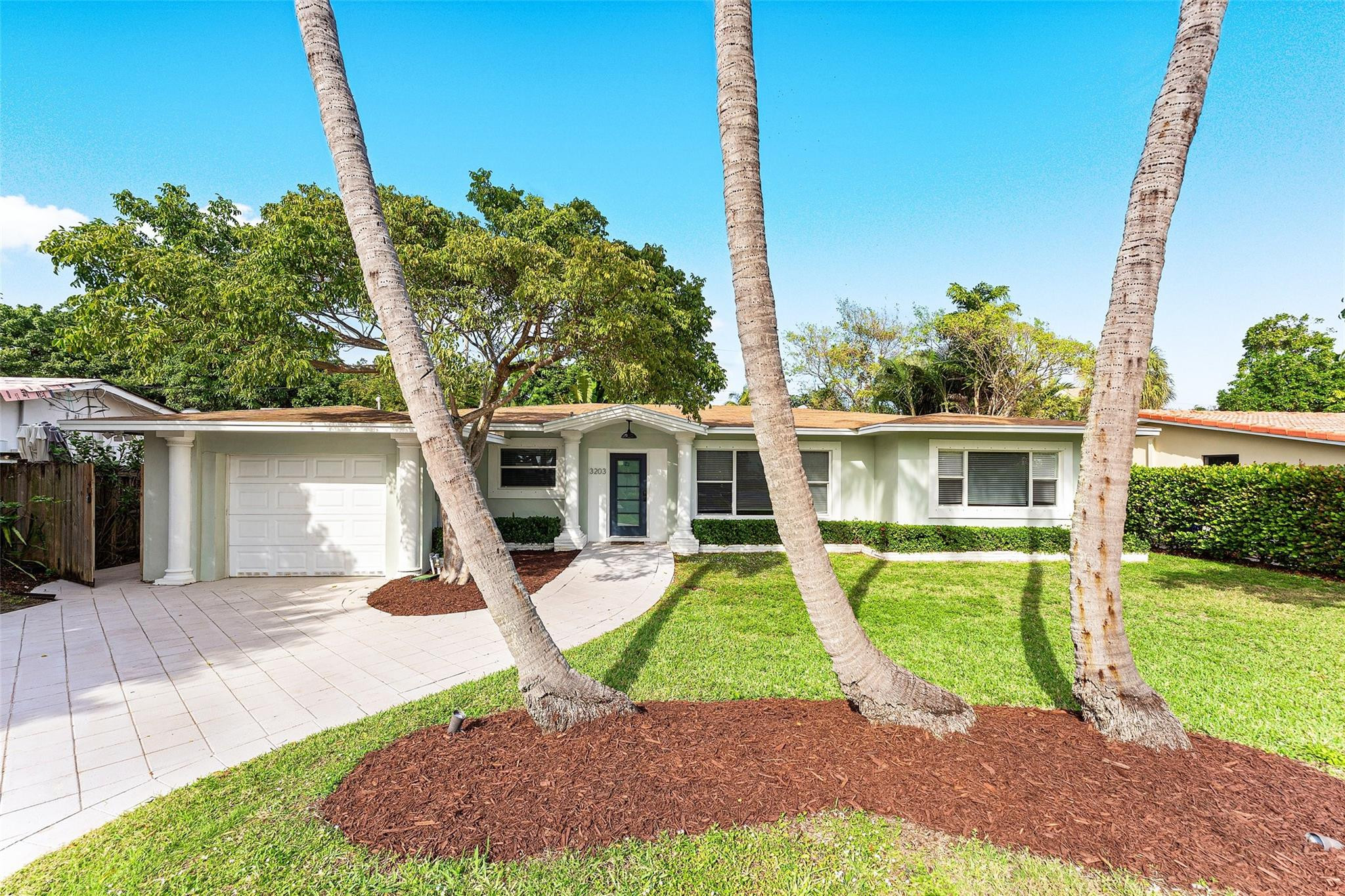 3203 Dover Road Pompano Beach, FL 33062 - Photo 3 of 45 a house with garden in front of it