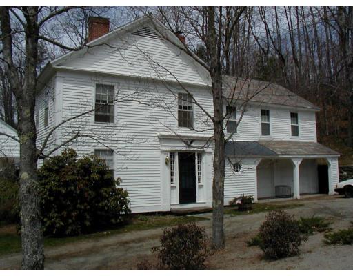 332 Zoar Road Rowe, MA 01367 - Photo 2 of 14 a front view of a house with a garden