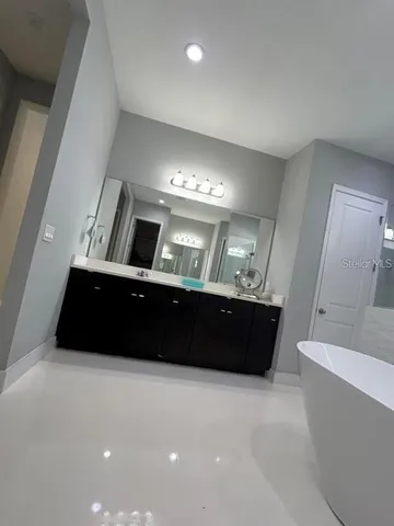 a living room with a couch and a large mirror