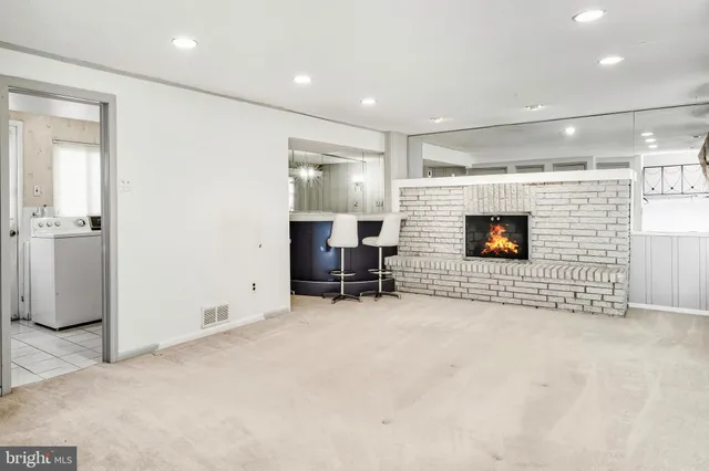 a view of empty room with wooden floor and fireplace
