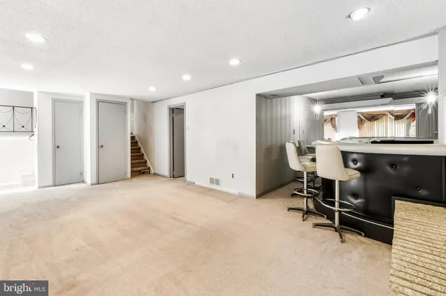 a view of a livingroom with furniture and a window
