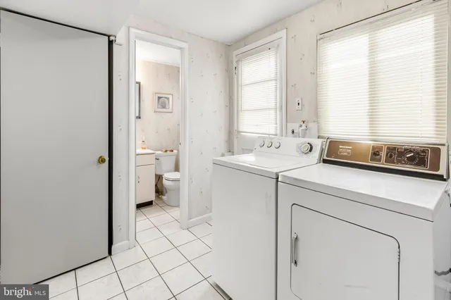 a en suite bathroom with a toilet a sink and a window