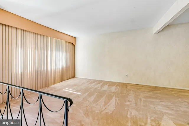 a view of an empty room and wooden floor