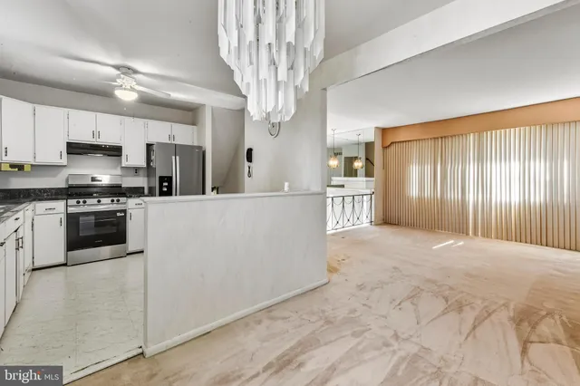 a large kitchen with cabinets and stainless steel appliances
