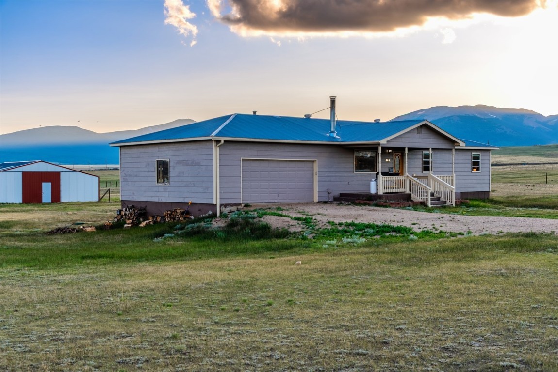 465 Litmer Road Jefferson, CO 80456 - Photo 1 of 50 Ranch-style house with a mountain view, an attached garage, and driveway